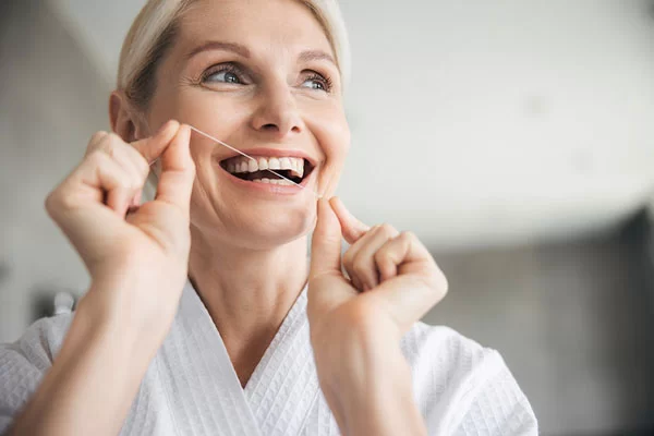 flossing her teeth