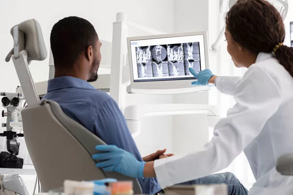 dentist showing patient his x-rays