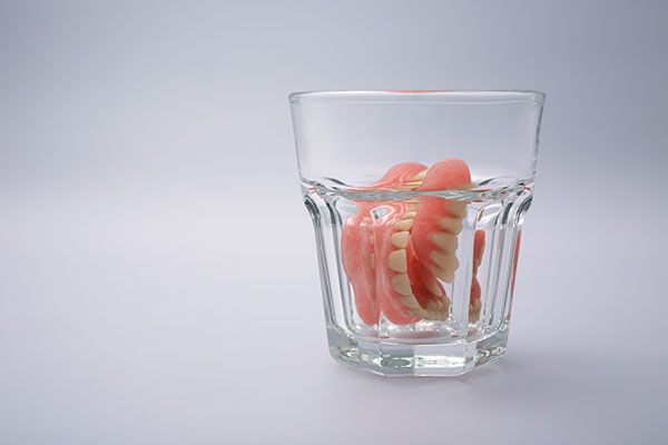 denture care; dentures soaking in water